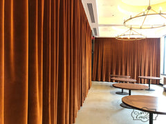 Gorgeous velvet drapery panels set a pleasant ambience at this Lux Restaurant. Ripple fold pleat heading.