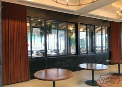 Gorgeous velvet drapery panels set a pleasant ambience at this Lux Restaurant. Ripple fold pleat heading.