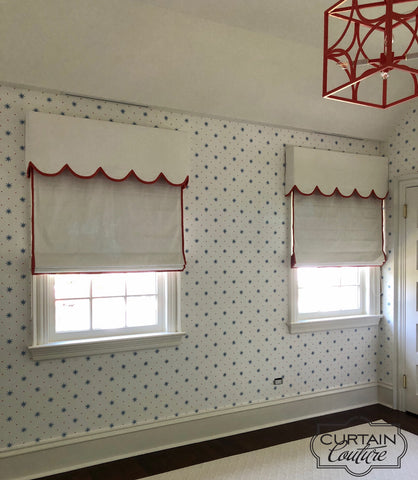White linen accents with ruby red decorative trim, flat roman shades and scalloped edge valances, create a playful ambiance in  the Girl's Room. Designed by Sally Brown and fabricated by Curtain Couture.